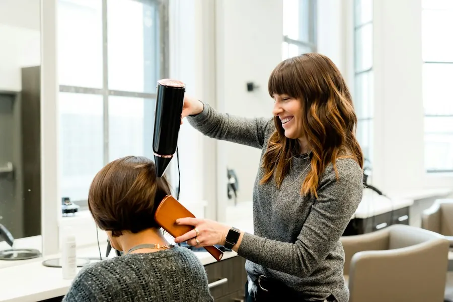 Stylist blow-drying a client's bob