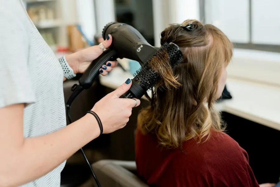 Stylist blow-drying long hair with a round brush