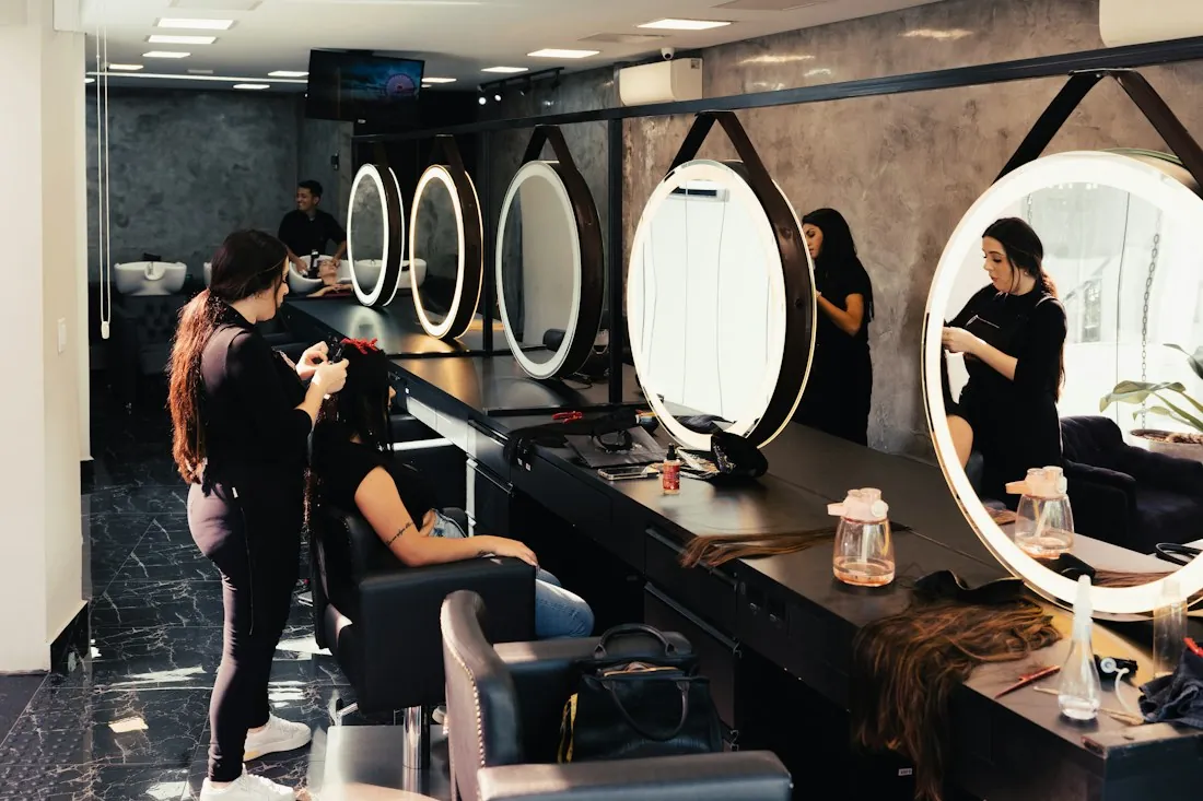 Inside a salon with round lit mirrors